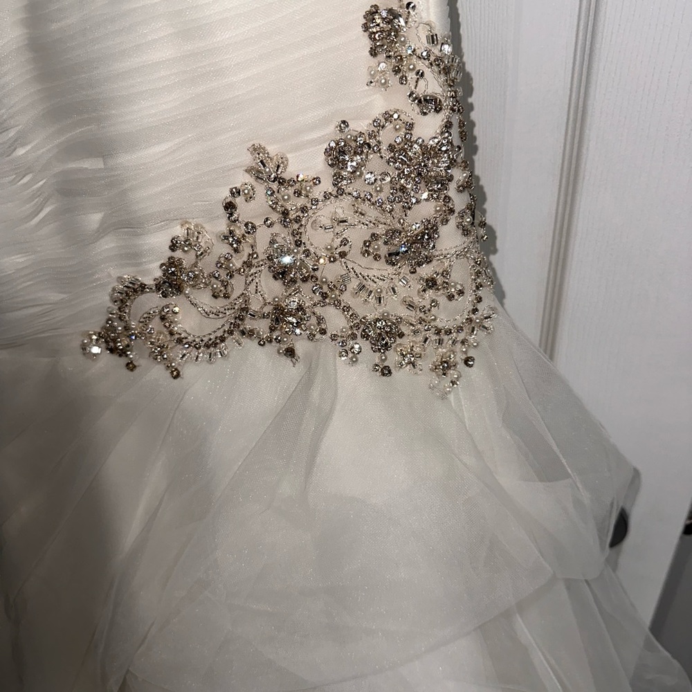 Size 12 wedding dress never worn but to try on. New with tag. Belt not included